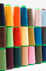 Colorful bobbin thread isolated on white background.