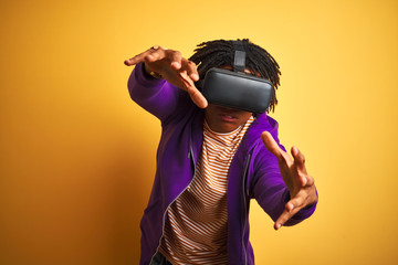 Young african american man playing virtual reality game using goggles