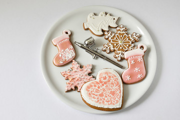 Christmas cookies and airbrush on a light plate.
