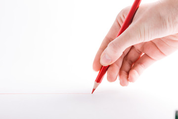 hand with the red pencil on a white background