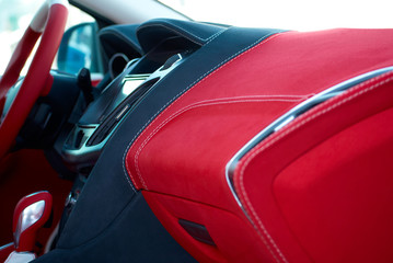 Car dashboard. Car interior details. Red and black alcantara with stitching
