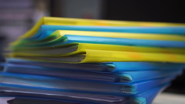Pile or Stack of file folders with documents binder on desk office. storage archive in business administration management information concept. 4k