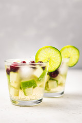 Green and red festive Christmas drink, apple cranberry white wine sangria. Selective focus, copy space.