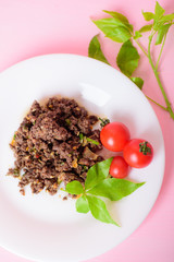 Spicy minced pork (Larb Moo) with fresh tomato, traditional northern Thai food