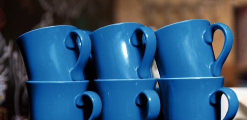 tableware and design concept - six stacked cups in trendy color of the year 2020 classic blue