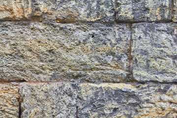 Large bricks, wall of yellow shell rock, texture of the old wall