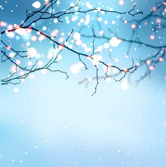 New year lights sparkle on branches. Christmas decorative blurred blue background. It's snowing in garden or in park. Festive winter illustration.