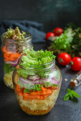 healthy salad in a jar (vegetable snack pasta salad) menu concept. food background. top view. copy space