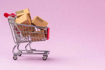 Paper boxes in shopping cart on Violet background with copy space. For online shopping business,...