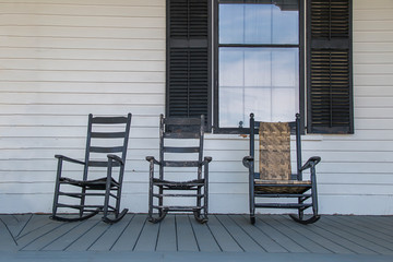 Wooden rocking chairs on a front porch