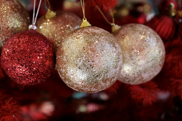 Christmas balls on a red fir branches in winter night. New Year tree with shining decorations, magic of the holiday