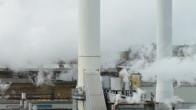 Static shot of UK infrastructure, Steam billowing from a Paper Mill in Kent, UK