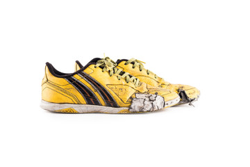 Old vintage damaged futsal sports shoes  on white background football sportware object isolated