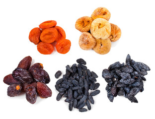 Heaps of dried fruits (fig, apricot, dates, raisins, prunes) isolated on a white background. Top view.