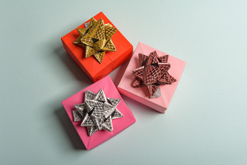 christmas presents nicely decorated with bows and feathers. view from above.