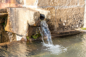 Fototapeta na wymiar A limestone water fountain in Geraci Siculo in Sicily, Italy