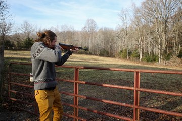 Young Generation Y or Millennial Male aged 20-30 demonstrating how to safely use a SKS firearm at an open shooting range