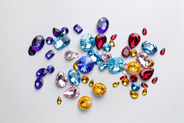 Different precious stones for jewellery on light background
