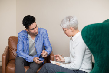 Fototapeta premium Consultation of young male patient on reception for psychologist. Family problems