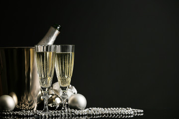 Champagne and Christmas decor on dark background