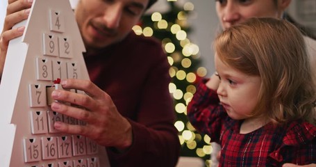 Handheld view of family with baby in Christmas time 