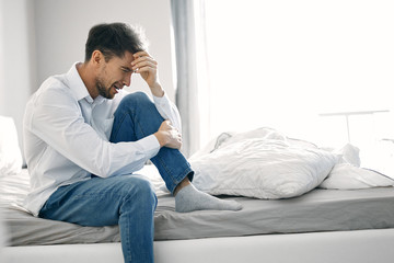 man sitting on sofa