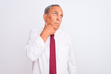 Senior grey-haired businessman wearing elegant tie over isolated white background with hand on chin thinking about question, pensive expression. Smiling with thoughtful face. Doubt concept.