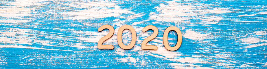 Happy new year 2020 on wooden blue background.