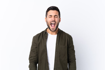 Fototapeta premium Young handsome man with beard over isolated white background shouting to the front with mouth wide open