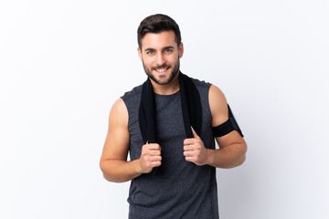 Young sport handsome man with beard over isolated white background with sport towel