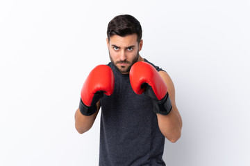 Young sport handsome man with beard over isolated white background with boxing gloves