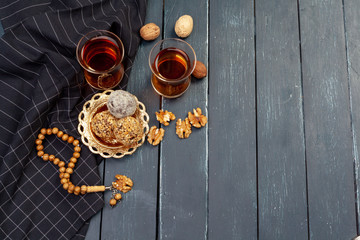 Nut balls dessert served with coffee on dark wooden table, top view