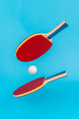 Red ping pong racket on a blue background