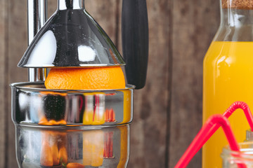 Orange juicer apparatus on kitchen table close up