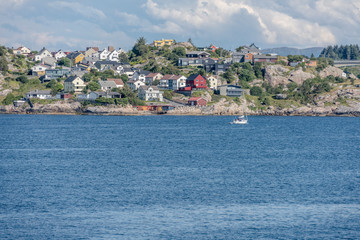 Fototapeta premium houses on green rocky shore, Kristiansund