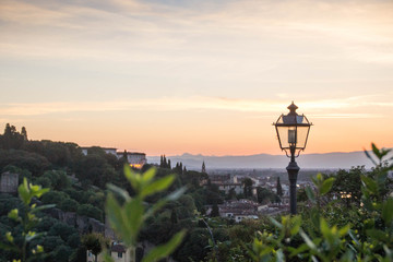 Bushes and a lamp at Piazzale Michelangelo, Florence, Italy, at sunset.