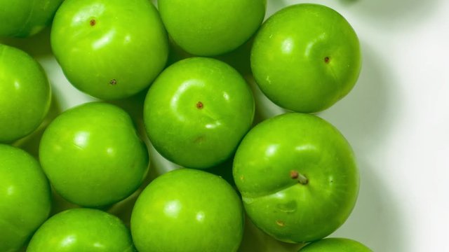 Closet up of pile of green plum fruit.