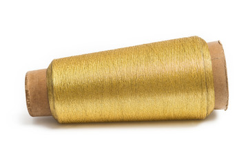 Spool of gold thread isolated on white background.