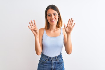 Beautiful redhead woman standing over isolated background showing and pointing up with fingers number nine while smiling confident and happy.