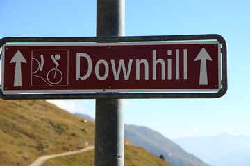 Downhill sign for mountain bikes single track descent close to Aletsch glacier in the Swiss alps