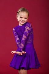 Portrait of a little girl in a purple dance dress