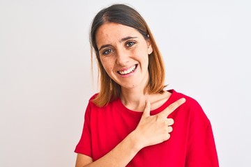 Fototapeta premium Beautiful redhead woman wearing casual red t-shirt over isolated background cheerful with a smile of face pointing with hand and finger up to the side with happy and natural expression on face