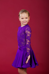 Portrait of a little girl in a purple dance dress