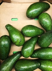 Delicious fresh avocado on the market view