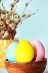 multicolored easter eggs and pussy willow branches for easter holiday