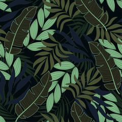 Summer seamless tropical pattern with bright green plants and leaves on black background.  Jungle leaf seamless vector floral pattern background. Beautiful seamless vector floral pattern.