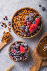 Morning  Granola, Fruits, Berries in bowl on grey concrete background. Healthy breakfast cereals. Concept of dieting, healthy  clean eating