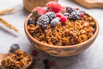 Morning  Granola, Fruits, Berries in bowl on grey concrete background. Healthy breakfast cereals. Concept of dieting, healthy  clean eating