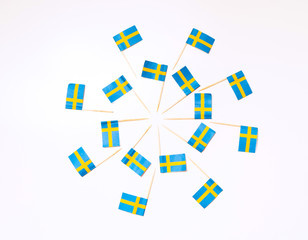 Swedish flags in the shape of two circles on the white background. Swedish flag concept. Scandinavian pattern.