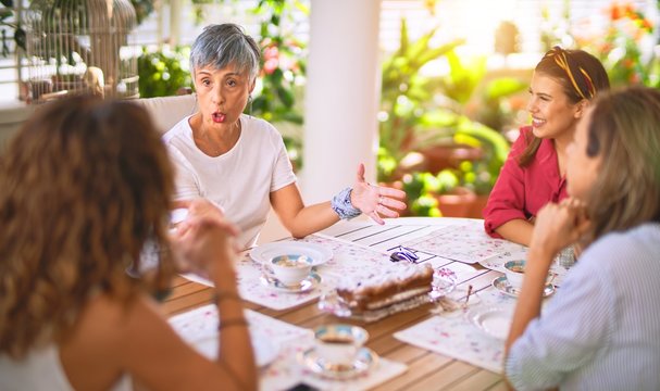 Young beautiful girl smiling happy and confident sitting dinking cup of coffee at terrace